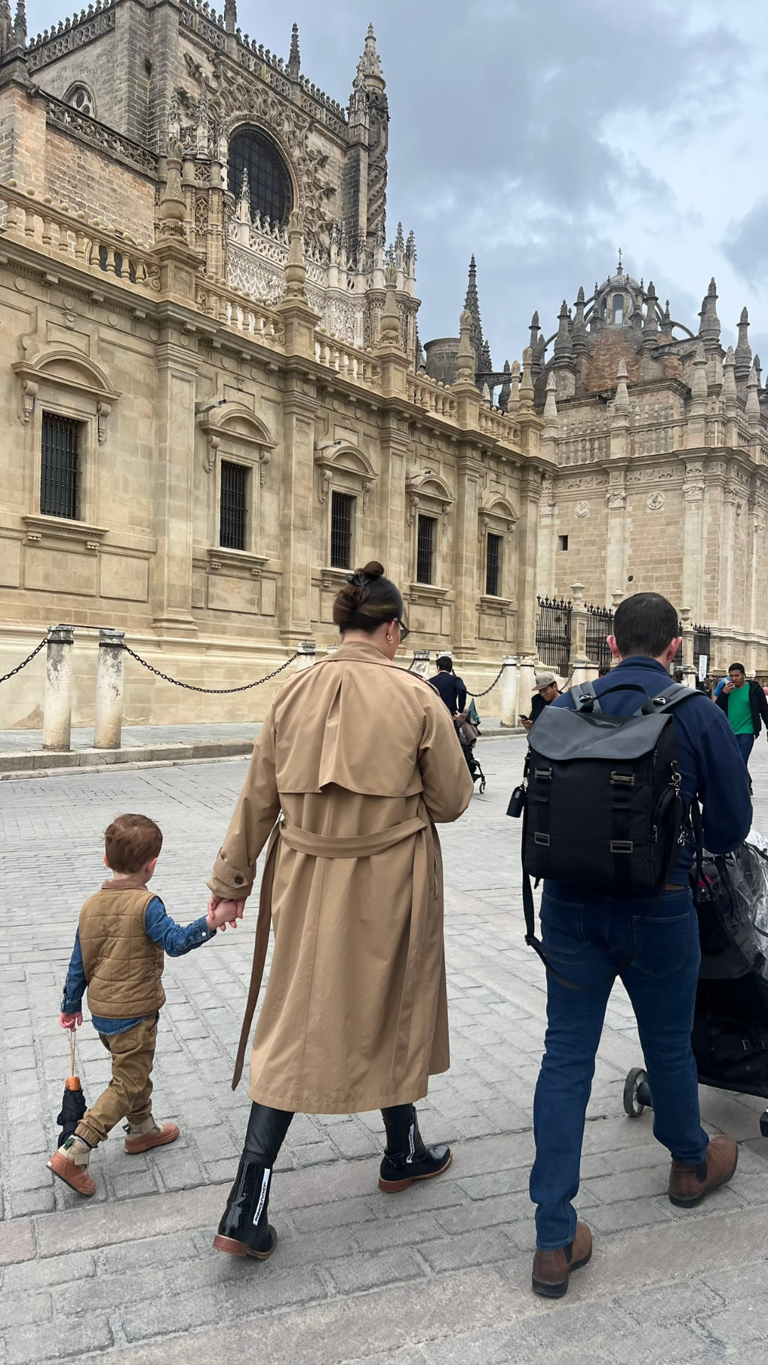 Walking hand in hand past the Sevilla Cathedral as a family