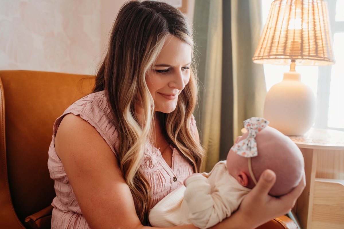Charlotte holding her newborn during her second maternity leave