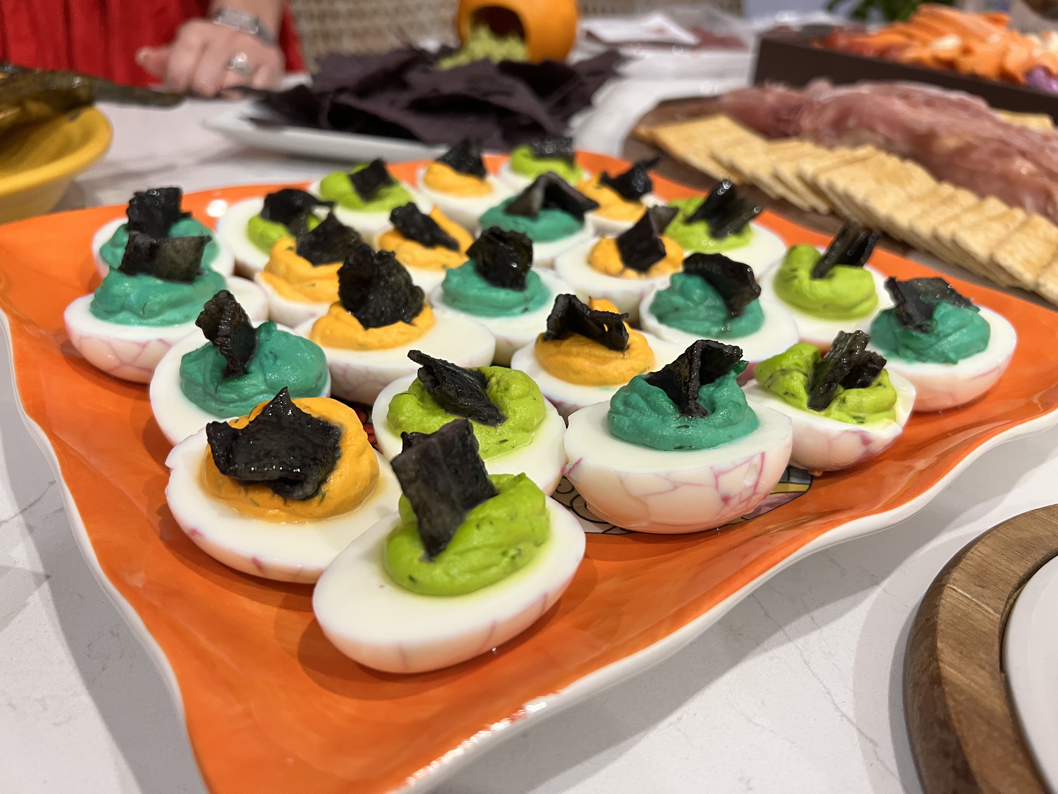 Spooky Halloween deviled eggs with marbled purple whites and colorful filling