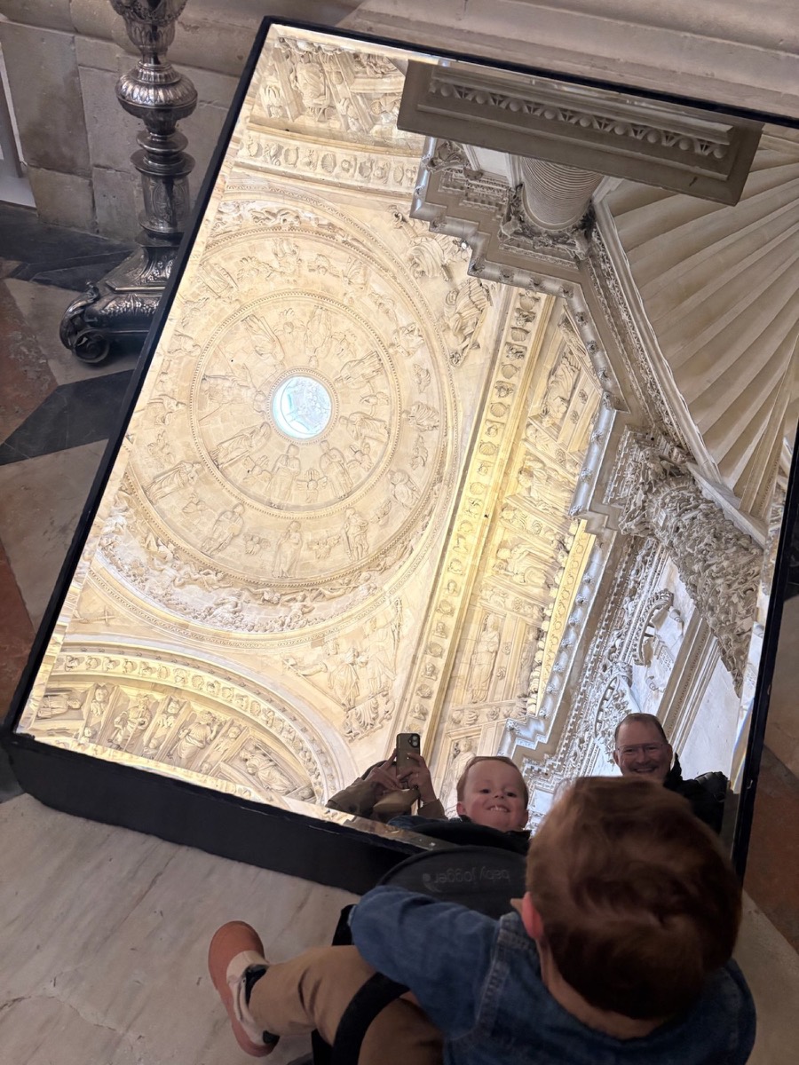 Checking out the intricate ceiling carvings with a mirror!